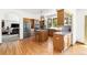 Open concept kitchen with wood floors, stainless steel appliances, and an island at 6252 King Dr, Evergreen, CO 80439
