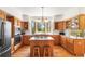 Spacious kitchen featuring custom cabinetry, island, and stainless steel appliances at 6252 King Dr, Evergreen, CO 80439