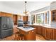 Bright kitchen with wooden cabinets, an island cooktop, and a double oven at 6252 King Dr, Evergreen, CO 80439