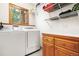 A laundry room with modern appliances, storage cabinets, and wire shelving at 6252 King Dr, Evergreen, CO 80439