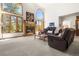 Cozy living room with a fireplace, comfortable seating, and natural light at 6252 King Dr, Evergreen, CO 80439