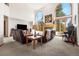 Spacious living room with large windows, fireplace, and comfortable seating at 6252 King Dr, Evergreen, CO 80439