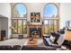 Elegant living room featuring a fireplace and scenic views from large windows at 6252 King Dr, Evergreen, CO 80439
