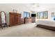 Bright main bedroom features vaulted ceilings and expansive windows with beautiful wooded views at 6252 King Dr, Evergreen, CO 80439
