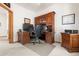 An office with a built-in desk, storage and a rolling office chair at 6252 King Dr, Evergreen, CO 80439