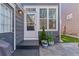 Charming backyard entrance features a stylish door and decorative potted plants enhancing the home's curb appeal at 1913 Julian St, Denver, CO 80204