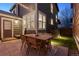 Well-lit backyard patio with a dining set, perfect for outdoor gatherings with a glimpse of the home's exterior at 1913 Julian St, Denver, CO 80204