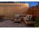 Relaxing backyard patio features cushioned outdoor seating and a wooden coffee table, ideal for unwinding at 1913 Julian St, Denver, CO 80204