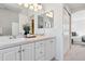 Bright bathroom features a vanity with double sinks, a large mirror, and framed artwork at 1913 Julian St, Denver, CO 80204