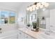 Bright bathroom features a soaking tub, vanity with double sinks, and framed artwork at 1913 Julian St, Denver, CO 80204