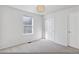 Bright bedroom features a window, closet, and neutral carpet at 1913 Julian St, Denver, CO 80204