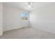 Bright bedroom with a ceiling fan, neutral carpet, and natural light from a window at 1913 Julian St, Denver, CO 80204