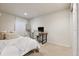 Bedroom with a bed, desk, chair, and a window allowing natural light into the room at 1913 Julian St, Denver, CO 80204