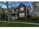 Well-maintained two-story home with a classic design, surrounded by lush greenery and a neatly kept lawn at 1913 Julian St, Denver, CO 80204