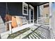 Inviting front porch with a comfortable porch swing adorned with decorative pillows, offering a relaxing outdoor space at 1913 Julian St, Denver, CO 80204