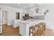 Modern kitchen with white cabinets, quartz countertops, stainless steel appliances, and a kitchen island with seating at 1913 Julian St, Denver, CO 80204