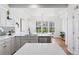 Spacious kitchen with stainless steel appliances, quartz countertops, and natural light streaming through the window at 1913 Julian St, Denver, CO 80204