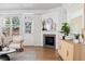Cozy living room featuring a fireplace, hardwood floors, stylish decor, and natural light at 1913 Julian St, Denver, CO 80204