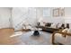 Bright living room with a neutral rug, comfortable seating, and staircase to the upper level at 1913 Julian St, Denver, CO 80204