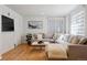 Well-lit living room with hardwood floors, a comfortable sofa, and stylish decor at 1913 Julian St, Denver, CO 80204