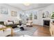 Bright living room with fireplace, stylish decor, and ample natural light at 1913 Julian St, Denver, CO 80204