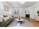 Spacious living room with a fireplace, hardwood floors, stylish decor, and plenty of natural light at 1913 Julian St, Denver, CO 80204