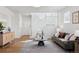 Inviting living room featuring hardwood floors, a staircase, stylish decor, and plenty of natural light at 1913 Julian St, Denver, CO 80204