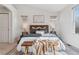 Comfortable main bedroom features a decorative bench, rug, and natural light from a large window at 1913 Julian St, Denver, CO 80204