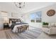 Bright main bedroom features a large window, rug, chair, and decorative chandelier at 1913 Julian St, Denver, CO 80204