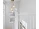 Bright staircase features white railing, decorative light fixture, and natural light from windows at 1913 Julian St, Denver, CO 80204