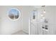 Bright staircase features white railing, decorative light fixture, and a unique circular window at 1913 Julian St, Denver, CO 80204