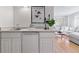 Modern wet bar area with white cabinets, stainless steel sink, and stylish accents at 1913 Julian St, Denver, CO 80204