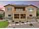 Backyard view featuring a two-story home with a patio and lush landscaping at 15506 Short Line Ct, Monument, CO 80132
