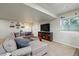 Cozy basement living area with a plush sectional sofa, a TV, and decor at 15506 Short Line Ct, Monument, CO 80132