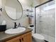 Well-lit bathroom featuring a modern shower with glass doors and updated fixtures at 15506 Short Line Ct, Monument, CO 80132