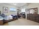 Spacious bedroom featuring a bed, desk, dresser, and large windows for ample natural light at 15506 Short Line Ct, Monument, CO 80132