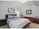 Comfortable bedroom with a queen bed, side tables, lamp and light gray walls at 15506 Short Line Ct, Monument, CO 80132