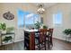 Bright dining area featuring large windows with views, a modern light fixture, and a wooden table at 15506 Short Line Ct, Monument, CO 80132