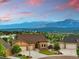 Beautiful home with mountain views featuring a manicured lawn and three-car garage at 15506 Short Line Ct, Monument, CO 80132