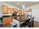 Modern kitchen featuring stainless steel appliances, granite countertops, and a central island with bar seating at 15506 Short Line Ct, Monument, CO 80132