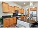 Well-lit kitchen has ample wood cabinetry, stainless appliances, and a beautiful granite countertop at 15506 Short Line Ct, Monument, CO 80132