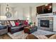 Comfortable living room showcasing a stone fireplace, hardwood floors, and elegant decor at 15506 Short Line Ct, Monument, CO 80132