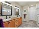 Bright bathroom includes dual sinks with wood cabinetry and stylish framed mirrors at 15506 Short Line Ct, Monument, CO 80132