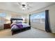Spacious main bedroom offers large windows, a ceiling fan, and cozy carpet at 15506 Short Line Ct, Monument, CO 80132