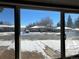 View of street and houses from window with some damage at 8551 Circle Dr, Westminster, CO 80031