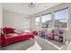 Bright bedroom with multiple windows, and colorful decor at 9532 Palmer Lake Ave, Littleton, CO 80125