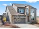 Beautiful two-story home showcasing a gray exterior with a well-maintained front yard and an attached two-car garage at 9532 Palmer Lake Ave, Littleton, CO 80125