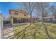 Expansive backyard with healthy lawn, shed, trees, and deck, creating an ideal outdoor living and entertainment space at 4593 S Field St, Littleton, CO 80123