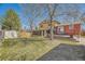 Well-maintained backyard with a green lawn, shed, patio with seating, and mature trees for shade and privacy at 4593 S Field St, Littleton, CO 80123
