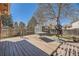 Spacious backyard with a wooden deck, shed, and mature tree, perfect for outdoor activities and relaxing at 4593 S Field St, Littleton, CO 80123